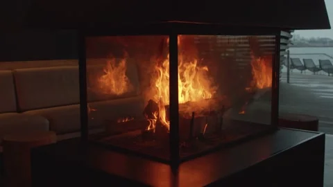 Tracking slow motion shot around a roaring fire in the middle of an empty room Stock Footage 146289489