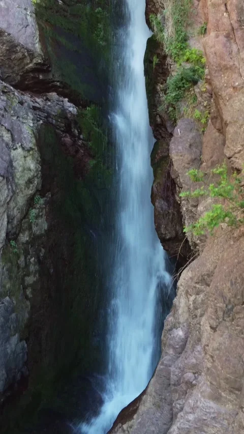 Tracking of a steep mountain cascade inside a narrow stone gap in Kazakhstan Видео 338128906