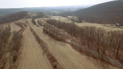 Tracking trucks by tree farm Stock Footage 72818910