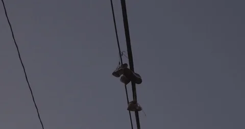 Tracking Under Overhead Wires With Shoes Hanging (Close Up) Stock Footage 86244699