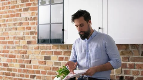 Tracking video of man with headphones refusing documents at home.  Stock Footage 156734456