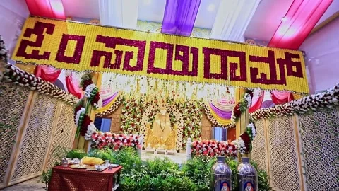 A tracking video of Sai Baba or Sai Ram idol surrounded by floral decoratio.. Video stock 328011502