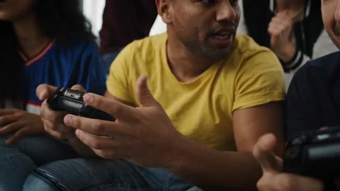 Tracking video of smiling friends playing a game console 스톡 동영상 130846841