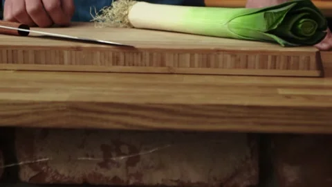 Tracking video of tossing leek in the kitchen Stock Footage 131589285
