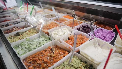 Tracking view of different kind of fresh salads, sauces and hummus that is on Stock Footage 181649512