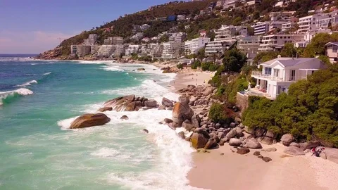 A tracking view over umbrellas and bathers on Clifton beach. Stock Footage 83125159