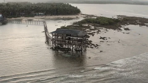 Tracking viewpoint drone shot of a pavillion with catwalk on the beach Stock Footage 103471804