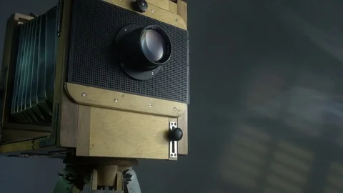 Tracking zoom out shot of old vintage wooden photo camera lighting by sunlight Stock Footage 75890719