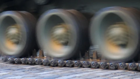 The tracks of the tanks are going on the paving Stock Footage 107620261
