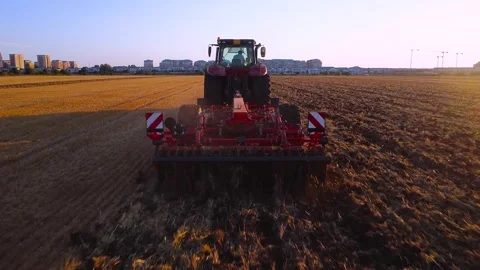 Tracktor harvesting at sunset Stock Footage 247251929