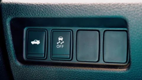 Traction control off and trunk release buttons on car dashboard Stock Footage 339521986