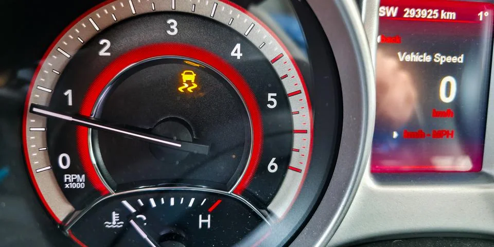 Traction control system warning light on dashboard when driving on slippery road Stock Photos