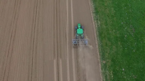 Tractor - aerial view of a tractor at work - cultivating a field in spring Stock Footage 74729795
