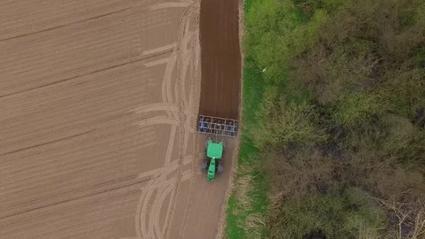 Tractor - aerial view of a tractor at work - cultivating a field in spring Stock Footage 74729981