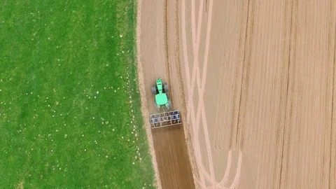 Tractor - aerial view of a tractor at work - cultivating a field in spring Stock Footage 74730444