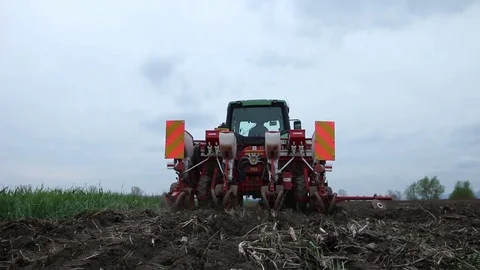 Tractor and corn seeding machine gone away Stock Footage 83474328