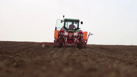 Tractor and corn seeding machine gone away Stock Footage 83474380