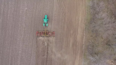 Tractor and cultivator work in the field. aerial view Stock Footage 129561153
