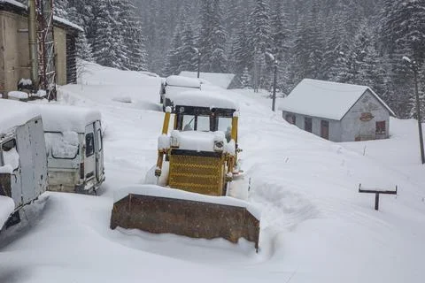 The tractor and old vehicles is covered with a thick layer of snow Stock Photos