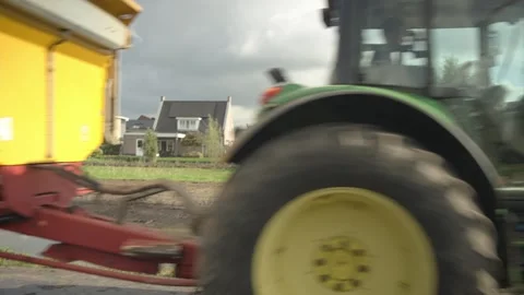 Tractor and Trailer Passing Camera on Dutch Farmland Vídeos de archivo 346882348