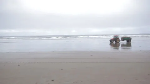Tractor and Trailor driving on Beach in Ireland Stock Footage 37349598