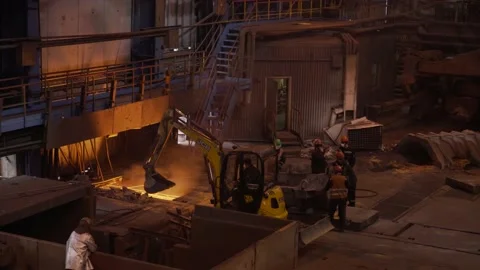 Tractor and workers in the process of working on a blast furnace. The workshop Stock-Footage 178377250