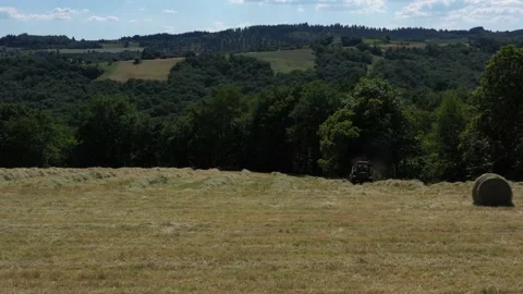 Tractor approaching while doing round baller Video stock 144540930