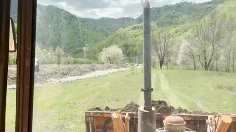Tractor bagger digs ground with large ground bucket shovel on constriction site Stock Footage 337453700