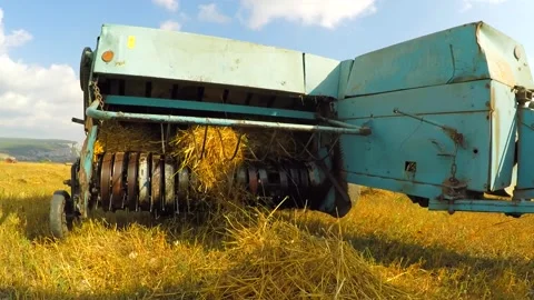 Tractor Baler Collecting Straw Left By Combine At Stubble Field Stock Footage 140281157