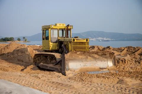 Tractor on the beach flattens Stock Photos