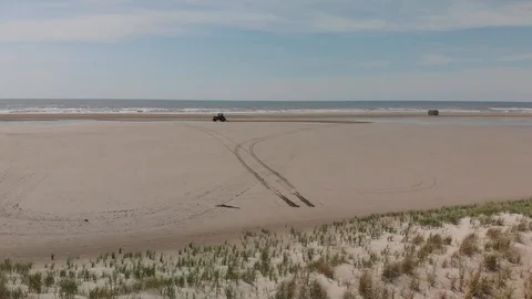 TRACTOR ON THE BEACH, GLIDING SHOT Stock Footage