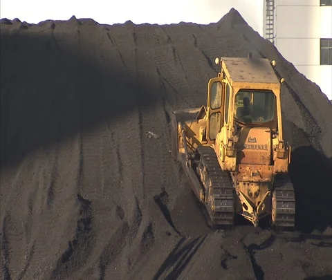 Tractor on big coal pile outside of Shenhua Sanhe power station Stock Footage 86746636