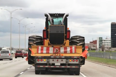 Tractor with big wheels on a flat bead Stock Photos