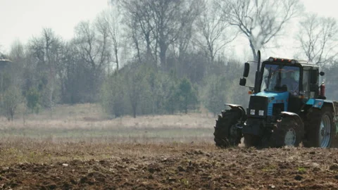 Tractor blue colour with big black wheels and a powerful grouser, heavy plows Stock Footage 106550210