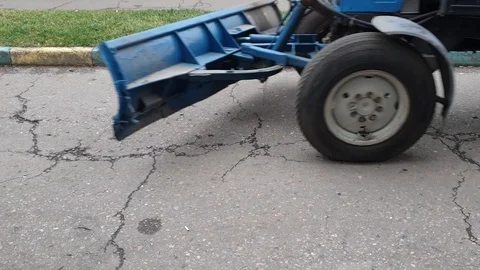 Tractor with a brush sweeping the road Stock Footage 119646449