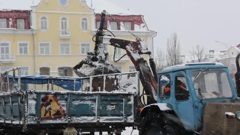 The tractor bucket cleans the snow Stock Footage 83647151