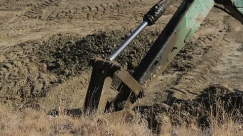 Tractor bucket digs the ground Stock Footage 60250442
