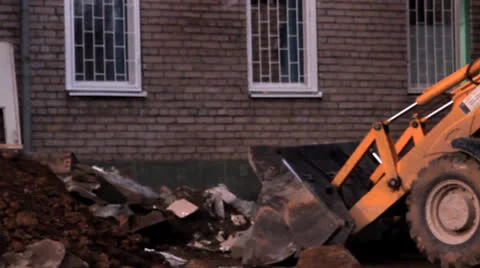 Tractor on building removes garbage, stones, sand 库存影片 22906855