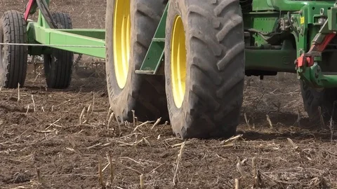 Tractor buries the field in the spring Stock Footage 128317392