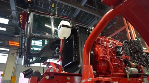 The tractor cab is suspended in the workshop on a crane beam, the engine is at  Stock Footage 148051290