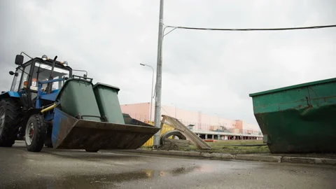 The Tractor Carries Garbage Cans to the Hazardous Waste Sorting Site Stock Footage 87332504