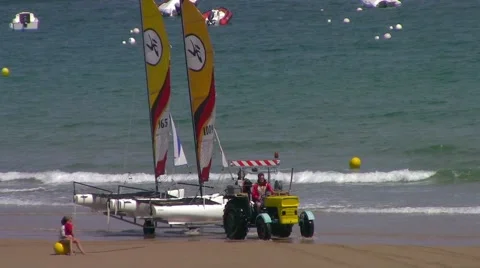 Tractor carrying small catamarans Stock Footage 66563660