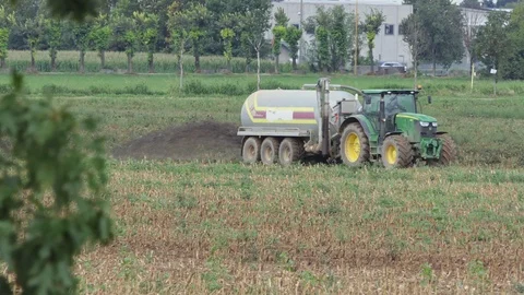 Tractor with cistern spreads manure Stock Footage 118154589