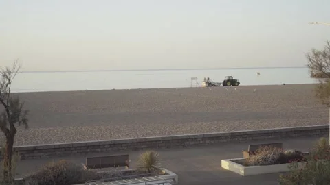 Tractor Cleaning and Sifting Sand on Empty Resort Beach in France Stock Footage 342437981