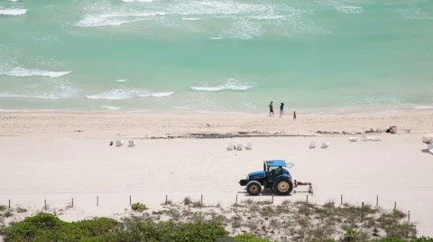 A tractor is cleaning the beach. Miami Beach, Florida. Full HD Video. Stock Footage 53198305