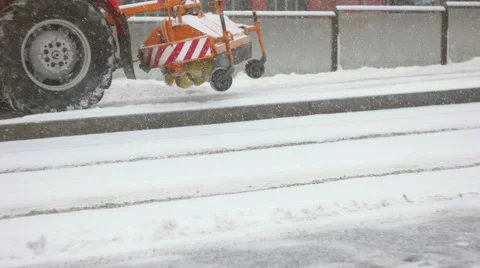 A tractor cleaning up fresh snow from the platform Stock Footage 59642307