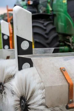 Tractor cleaning reflector posts Stock Photos