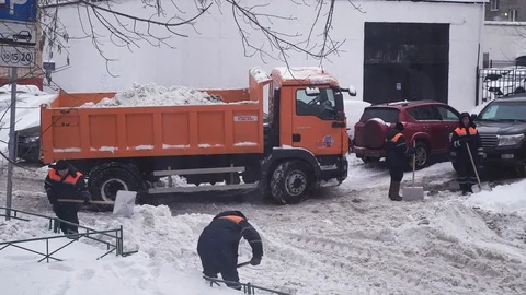 Tractor cleaning the road from the snow. Workers sweep snow from road in winter Stock Footage 85624217