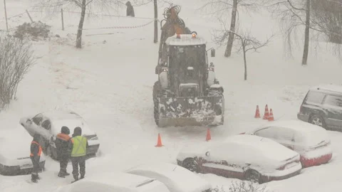 Tractor cleaning the streets from snow in snowfall Video stock 148543793
