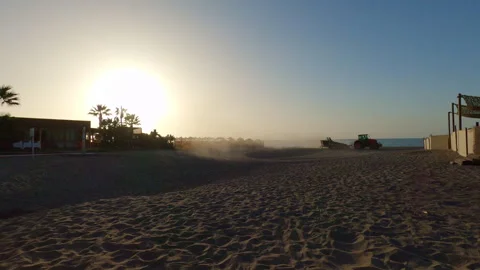 A tractor cleans the sandy Mediterranean beach preparing the shoreline Stock Footage 339932137